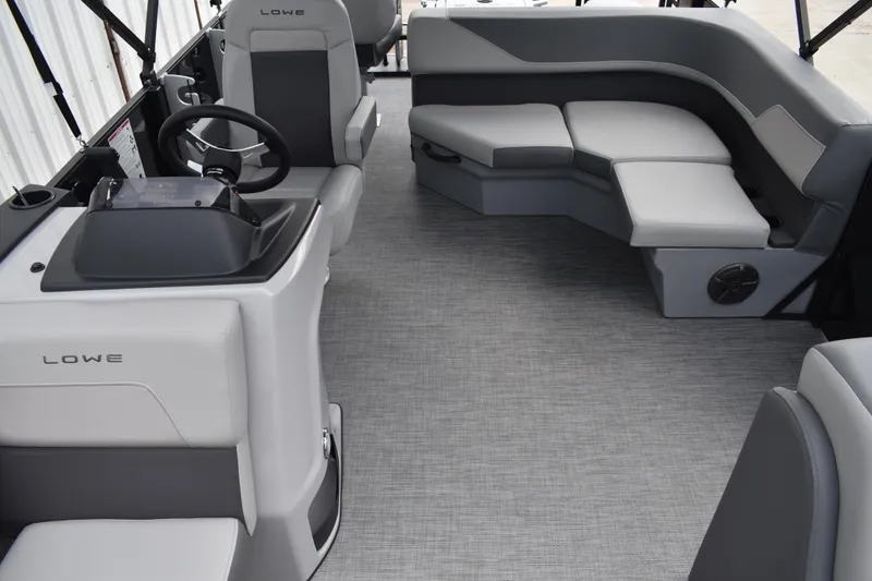 Slide: The Image of Luxurious seating area on 2026 Lowe LF 232 boat, featuring sleek gray upholstery. - 30