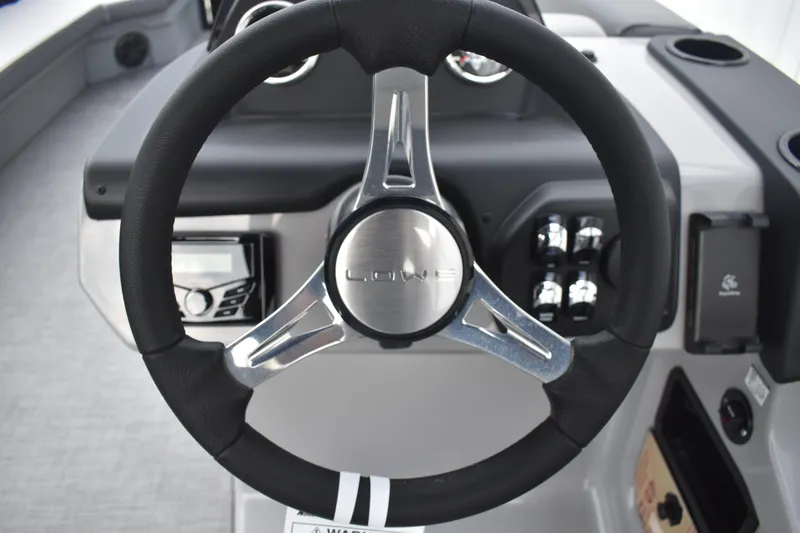 Slide: The Image of Interior of 2026 Lowe LF 232 boat with storage compartment and cup holders. - 35