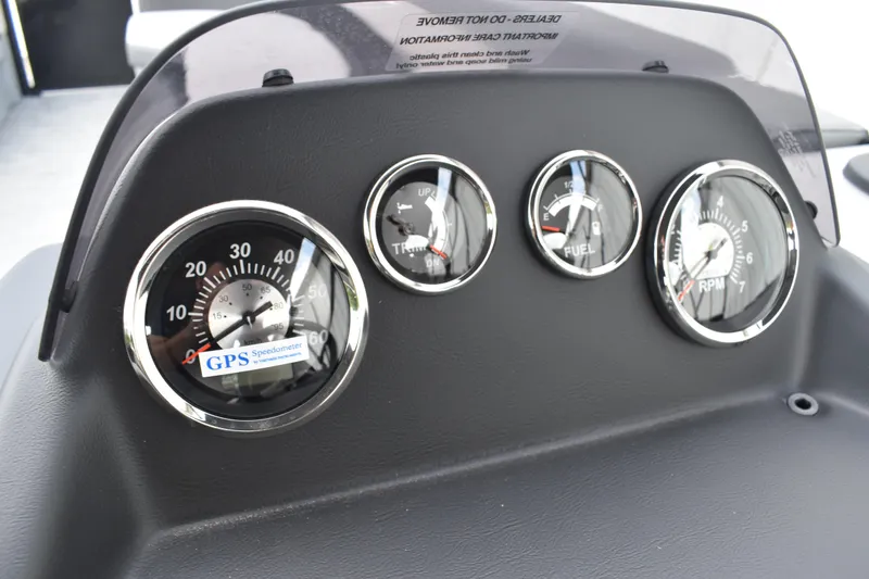 Slide: The Image of 2026 Lowe LF 232 boat interior with rod holders and gray flooring. - 37