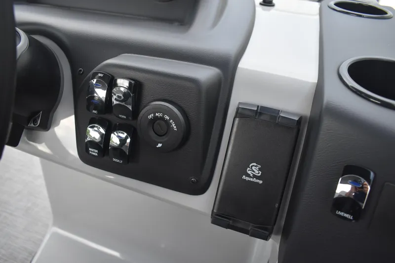 Slide: The Image of Open storage compartment with cup holders in a 2026 Lowe LF 232 boat. - 38