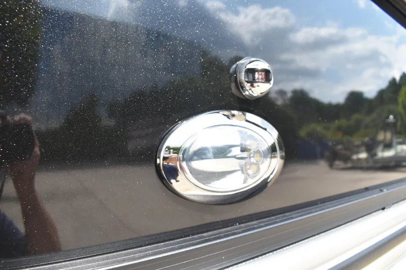 Slide: The Image of 2026 Lowe LF 232 pontoon boat on trailer, black canopy, parked outdoors. - 5