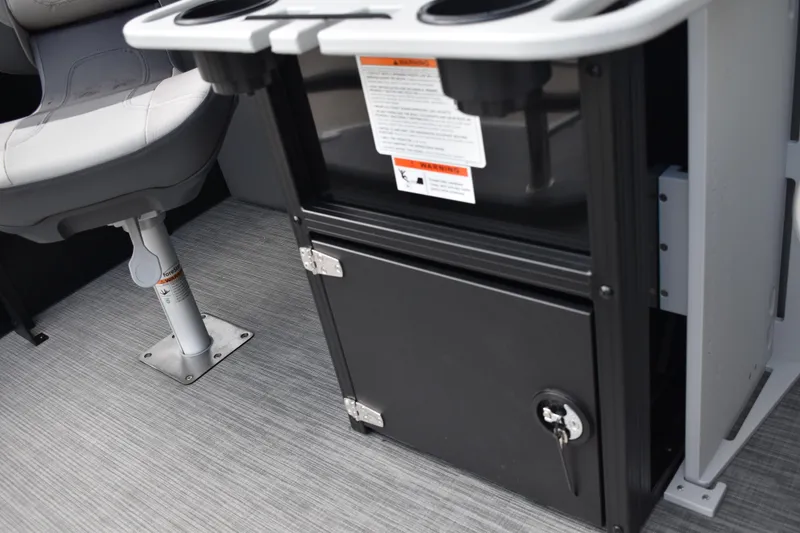 Slide: The Image of Open storage compartment with cup holders in a 2026 Lowe LF 232 boat. - 50