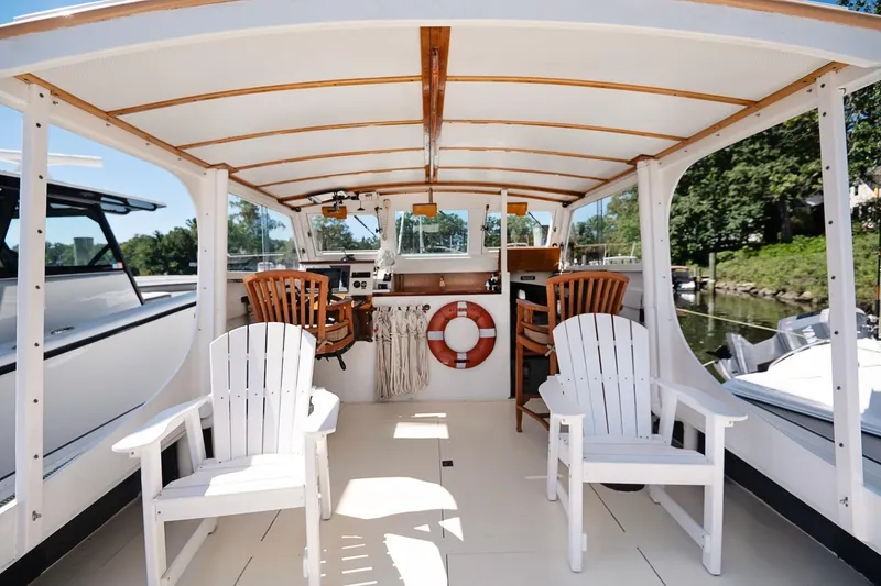 Slide: The Image of 1972 Jarvis Newman Downeast boat interior with wooden chairs and life preserver. - 12