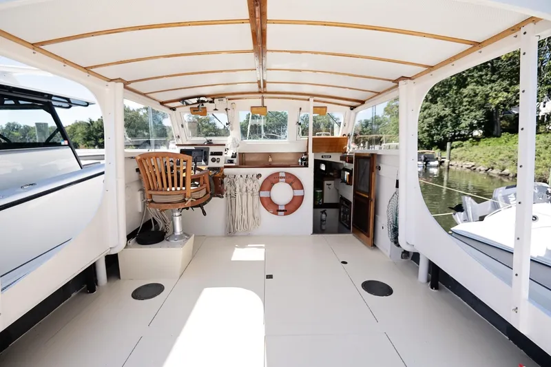 Slide: The Image of 1972 Jarvis Newman Downeast boat interior with wooden chair and life preserver. - 13