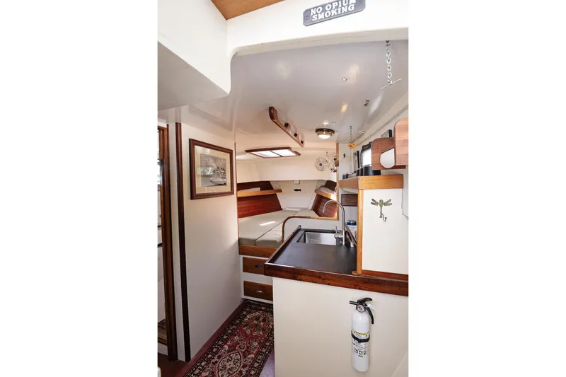 Slide: The Image of Interior of a 1972 Jarvis Newman Downeast boat, featuring a cozy cabin and kitchenette. - 19