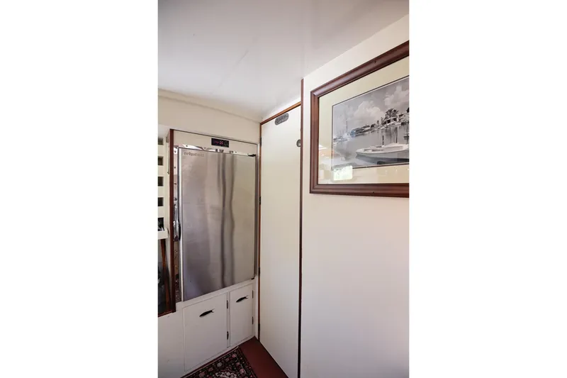 Slide: The Image of Interior of 1972 Jarvis Newman Downeast boat with stainless steel fridge and framed photo. - 24