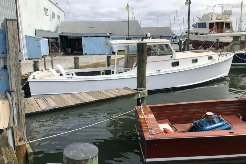 Slide: The Image of 1972 Jarvis Newman Downeast boat docked at a marina, surrounded by other vessels. - 3