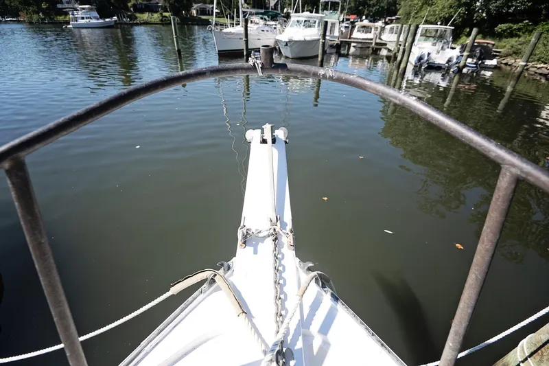 Slide: The Image of Bow view of 1972 Jarvis Newman Downeast boat docked in a serene marina. - 30