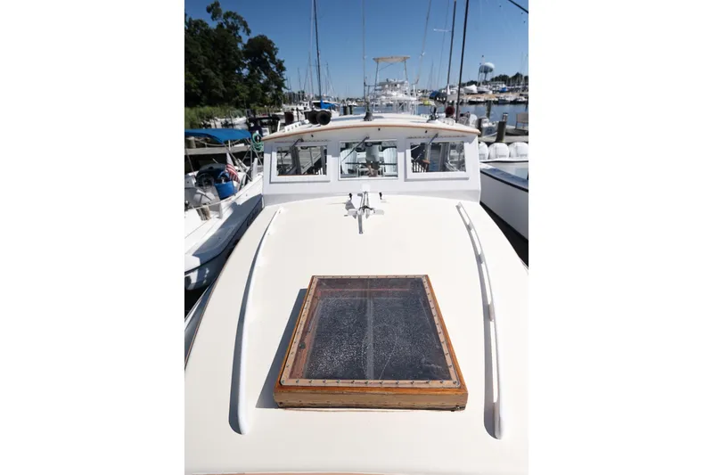 Slide: The Image of 1972 Jarvis Newman Downeast boat docked at a marina, showcasing its classic design. - 31
