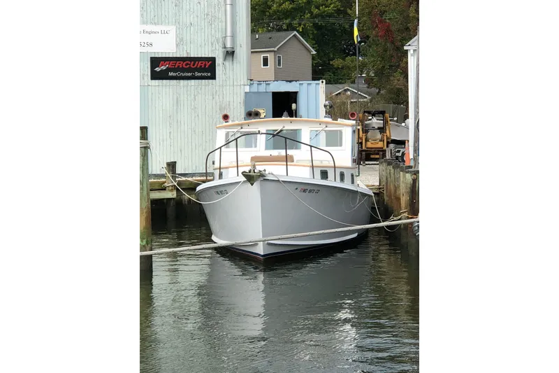 Slide: The Image of 1972 Jarvis Newman Downeast boat docked near Mercury service building. - 4
