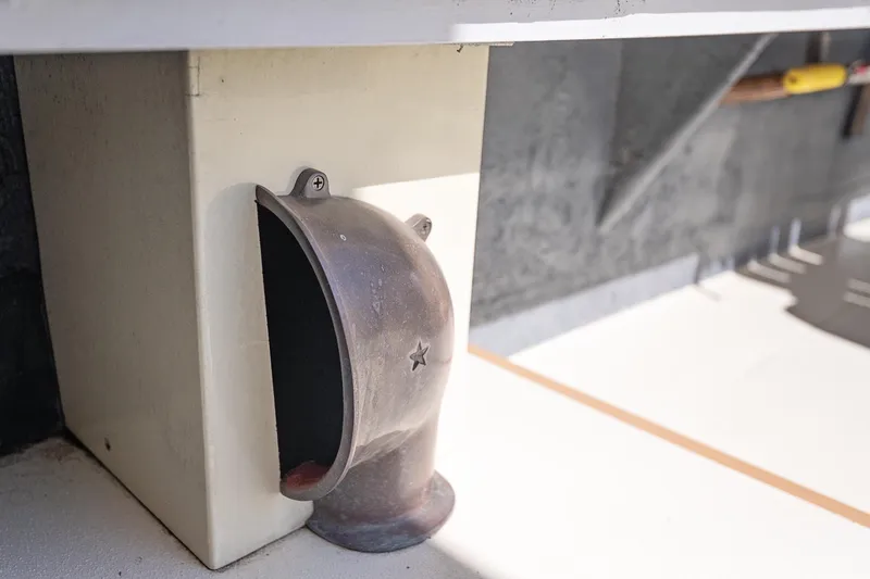 Slide: The Image of 1972 Jarvis Newman Downeast boat detail showing a metal vent with a star design. - 40