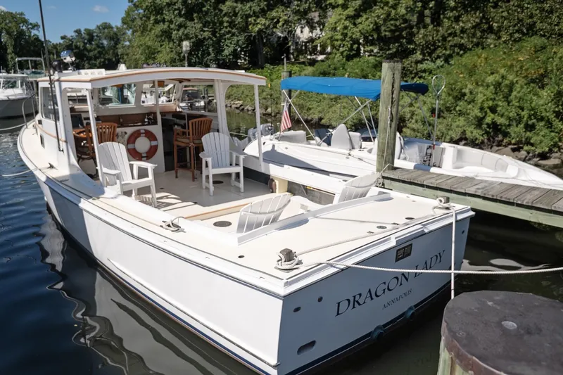 Slide: The Image of 1972 Jarvis Newman Downeast boat "Dragon Lady" docked, featuring spacious deck and seating. - 5