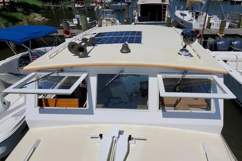 Slide: The Image of 1972 Jarvis Newman Downeast boat with solar panel and open windows at dock. - 8