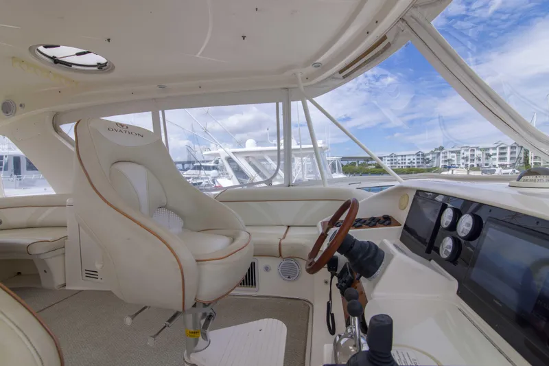 Slide: The Image of Interior view of 2009 Silverton Oviation 52 yacht cockpit with luxurious seating and controls. - 12