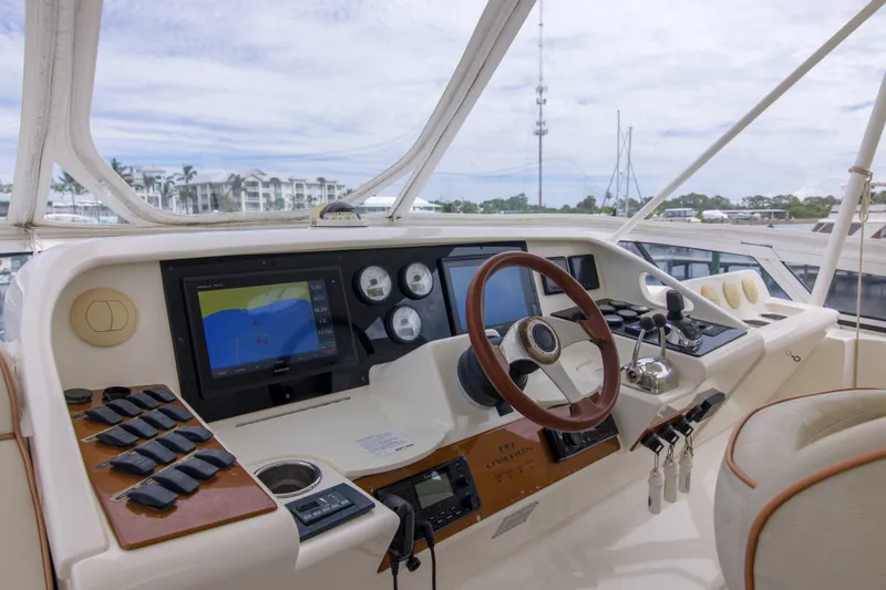 Slide: The Image of 2009 Silverton Oviation 52 yacht helm with navigation screens and controls. - 15