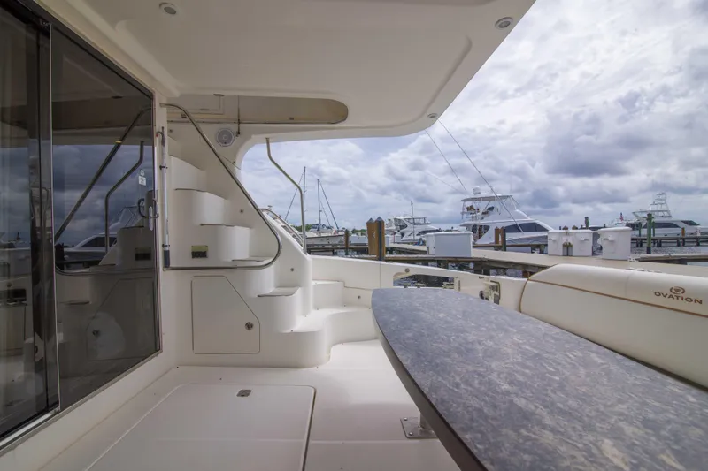 Slide: The Image of 2009 Silverton Oviation 52 yacht interior with elegant seating and marina view. - 21