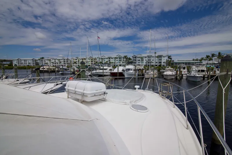 Slide: The Image of 2009 Silverton Oviation 52 yacht docked at marina with scenic waterfront view. - 25