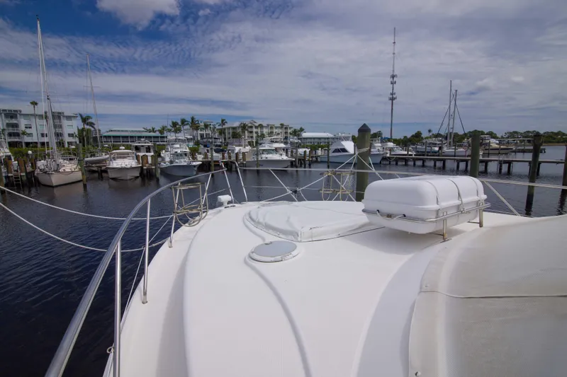 Slide: The Image of 2009 Silverton Oviation 52 yacht docked at marina with clear sky and calm waters. - 29