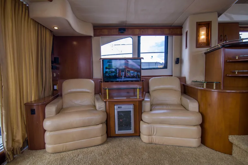 Slide: The Image of Luxurious interior of 2009 Silverton Oviation 52 yacht with leather chairs and entertainment center. - 34