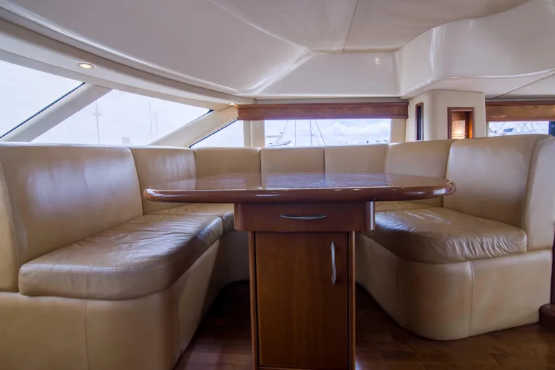 Slide: The Image of Luxurious interior of 2009 Silverton Oviation 52 yacht with leather seating and wooden table. - 39