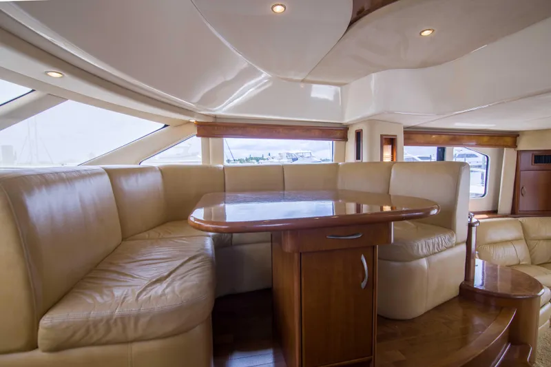 Slide: The Image of Luxurious interior of 2009 Silverton Oviation 52 yacht with leather seating and wooden table. - 44