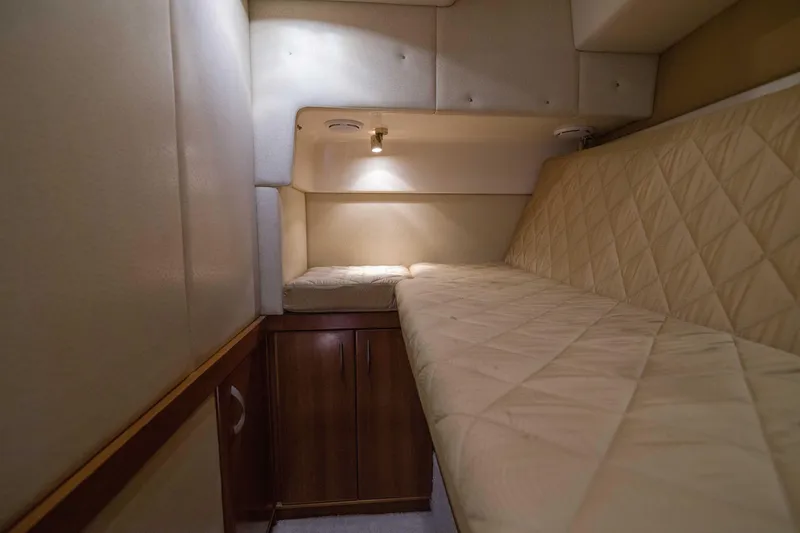 Slide: The Image of Interior cabin of 2009 Silverton Oviation 52 yacht with beige quilted bedding. - 45