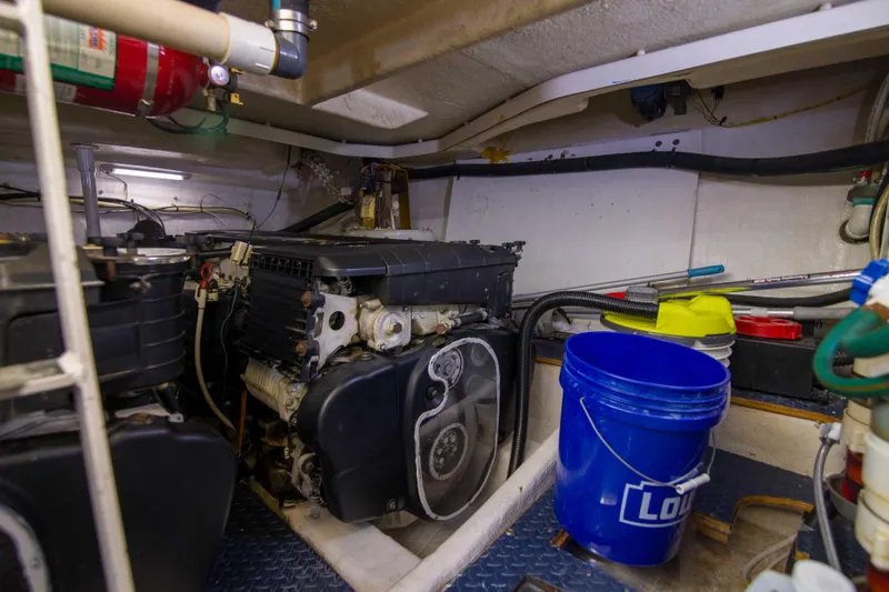 Slide: The Image of Engine room of 2009 Silverton Oviation 52 yacht with equipment and blue bucket. - 58