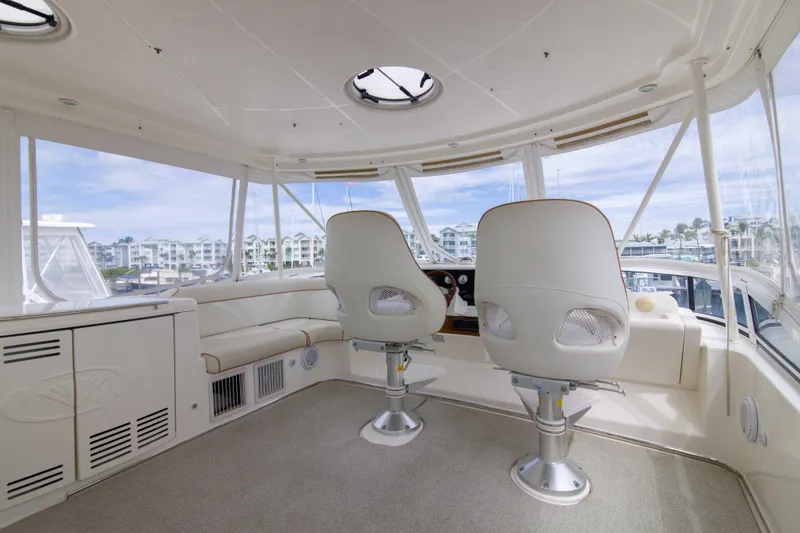 Slide: The Image of Interior of 2009 Silverton Oviation 52 yacht with helm chairs and panoramic windows. - 8