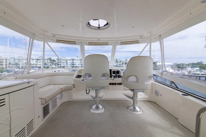 Slide: The Image of Interior view of 2009 Silverton Oviation 52 yacht cockpit with two captain chairs. - 9