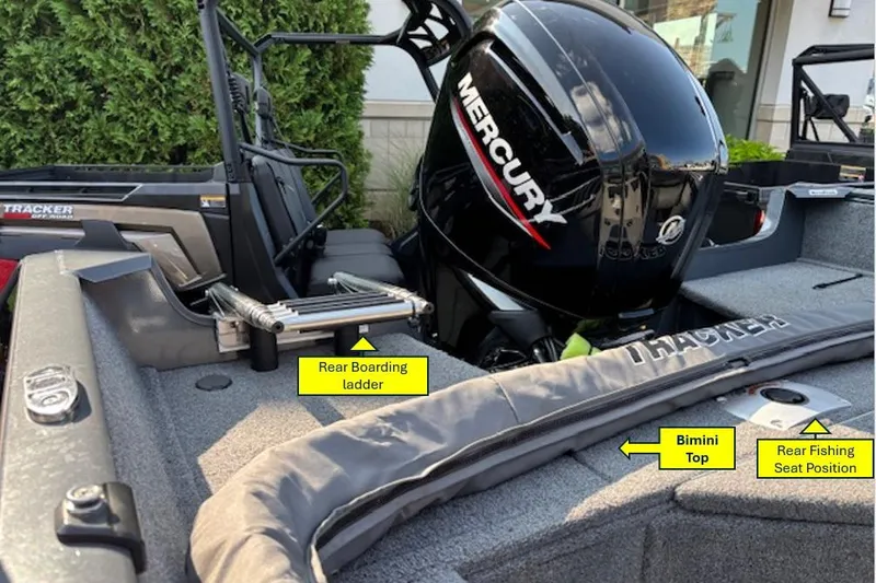 Slide: The Image of 2022 Tracker PGV16 boat with Mercury engine, rear boarding ladder, bimini top, and fishing seat position. - 4