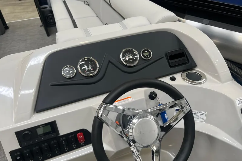 Slide: The Image of 2023 Crest LX 240 SLC boat dashboard with steering wheel and gauges. - 5