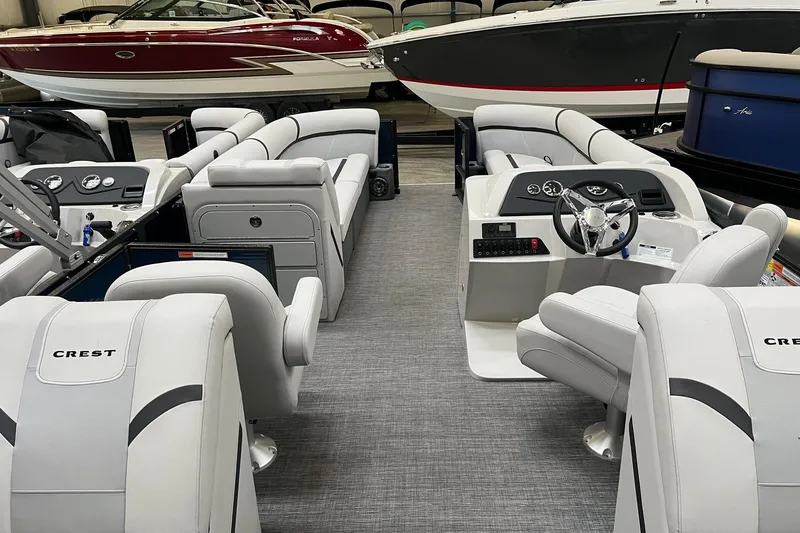 Slide: The Image of 2023 Crest LX 240 SLC pontoon boat interior with luxurious seating and modern dashboard. - 6