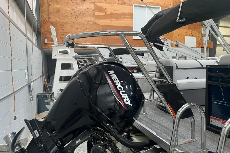 Slide: The Image of 2023 Crest LX 240 SLC pontoon boat with Mercury outboard motor in showroom. - 7