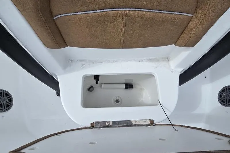 Slide: The Image of 2026 Sea Hunt BX 22 BR boat storage compartment with brown seating and white interior. - 10