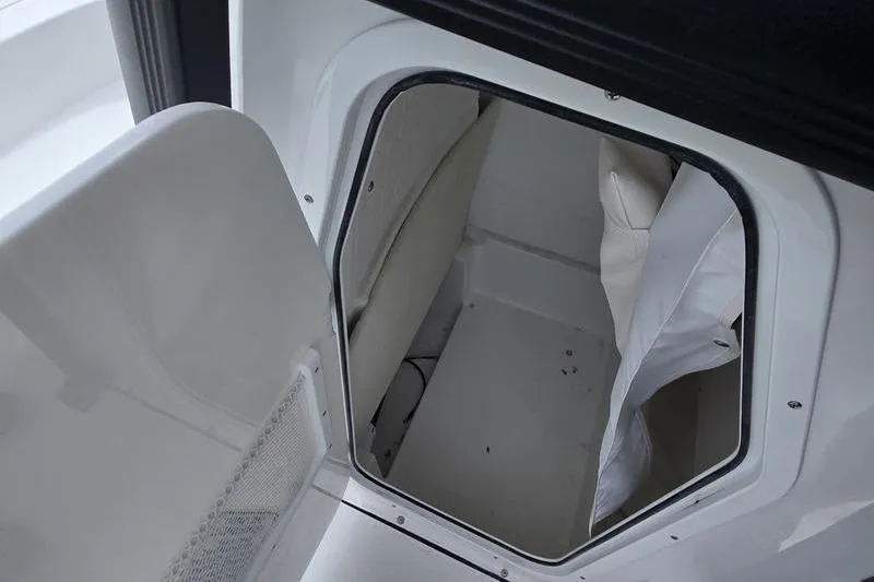 Slide: The Image of 2026 Sea Hunt BX 22 BR storage compartment with open hatch, showcasing interior space. - 11