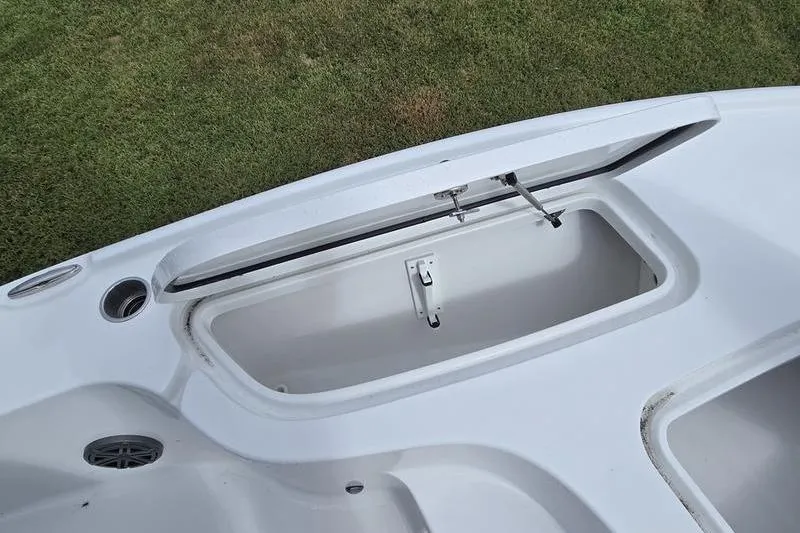 Slide: The Image of Open storage compartment on 2026 Sea Hunt BX 22 BR boat, showing interior details. - 12