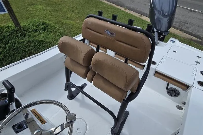 Slide: The Image of 2026 Sea Hunt BX 22 BR boat with tan cushioned seating and steering wheel. - 13