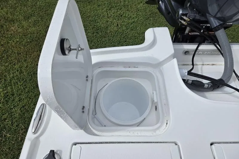 Slide: The Image of 2026 Sea Hunt BX 22 BR boat with open storage compartment and bucket. - 3