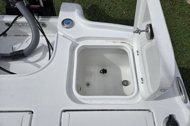 Slide: The Image of 2026 Sea Hunt BX 22 BR boat storage compartment with open lid, showcasing interior details. - 5