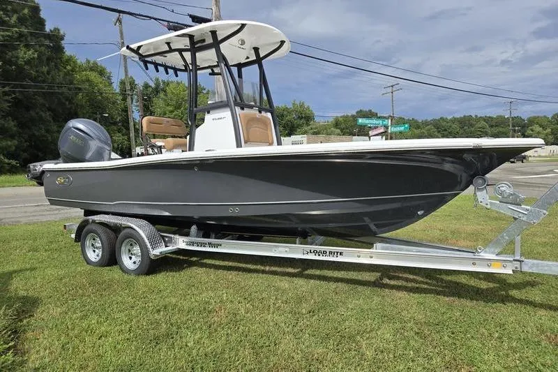 Slide: The Image of 2026 Sea Hunt BX 22 BR boat on trailer, parked on grass. - 6