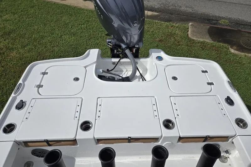 Slide: The Image of 2026 Sea Hunt BX 22 BR boat deck with motor, featuring storage compartments and rod holders. - 7