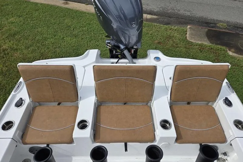 Slide: The Image of 2026 Sea Hunt BX 22 BR boat with three tan seats and an outboard motor. - 9