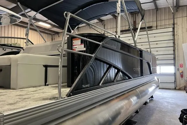 Slide: The Image of 2023 Crest LX 240SLSC pontoon boat in a warehouse, showcasing sleek design and modern features. - 3