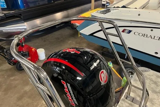 Slide: The Image of 2023 Crest LX 240SLSC boat with Mercury engine in a showroom. - 9