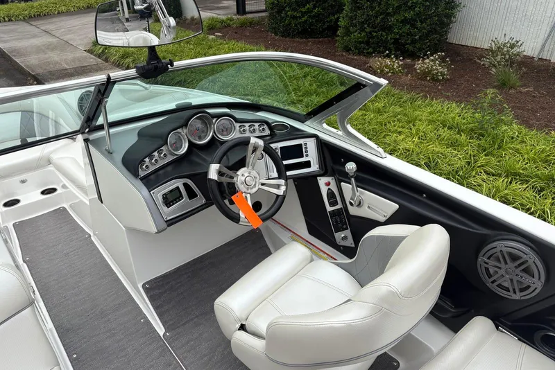 Slide: The Image of 2014 MasterCraft X10 boat interior with steering wheel, dashboard, and seating. - 13