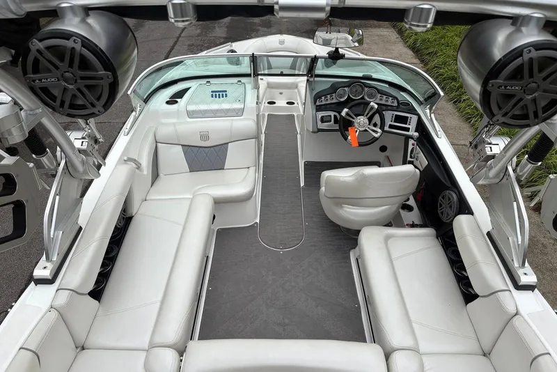 Slide: The Image of 2014 MasterCraft X10 boat interior with white seating and advanced audio system. - 14
