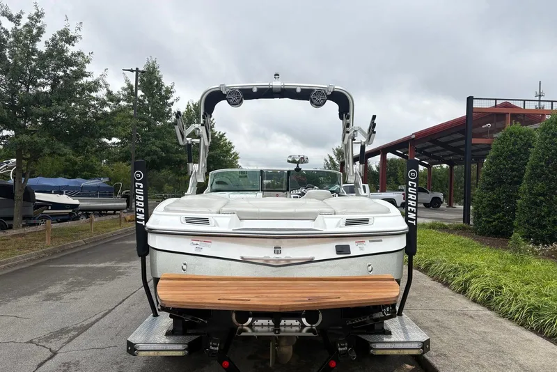 Slide: The Image of 2014 MasterCraft X10 boat, rear view, parked outdoors on a cloudy day. - 3