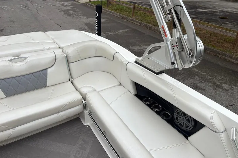 Slide: The Image of 2014 MasterCraft X10 boat interior with white leather seating and speaker system. - 9