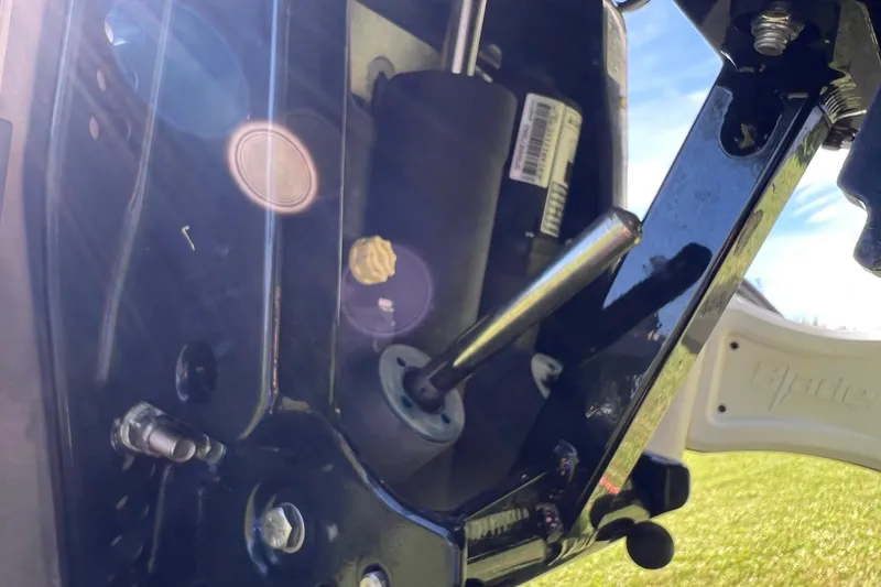 Slide: The Image of Close-up of 2020 Key West 230 Bay Reef boat engine components with sunlight reflections. - 23