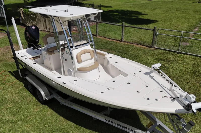 Slide: The Image of 2020 Key West 230 Bay Reef boat on trailer, parked on grass. - 3